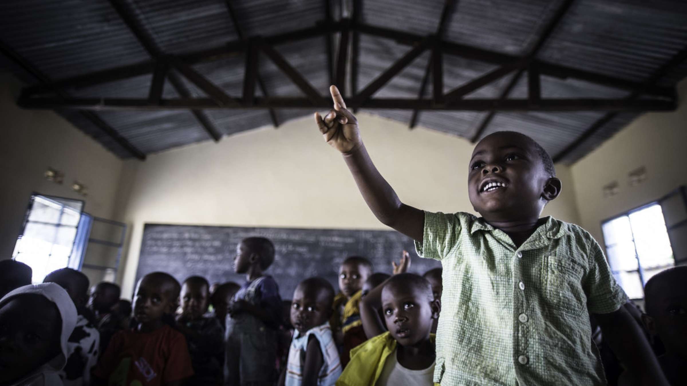 A boy raises his hand in class. Burundi
